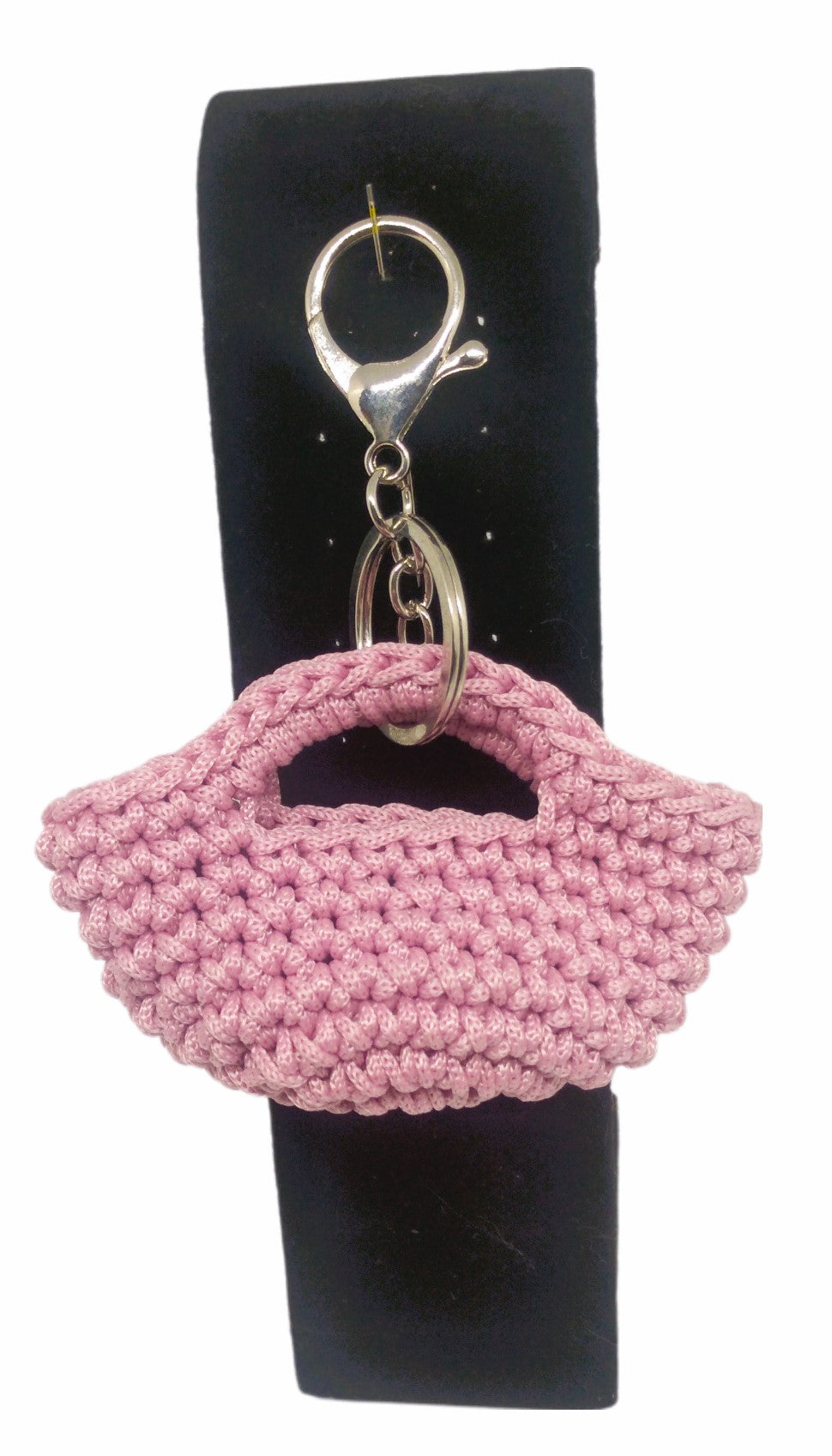 Front view of pink/silver mini handbag keychain on stand