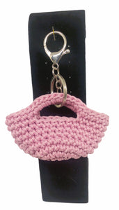 Front view of pink/silver mini handbag keychain on stand