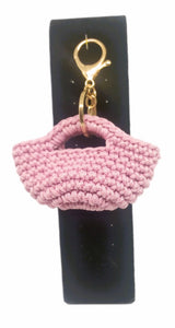 Front view of Pink/gold mini handbag keychain on stand
