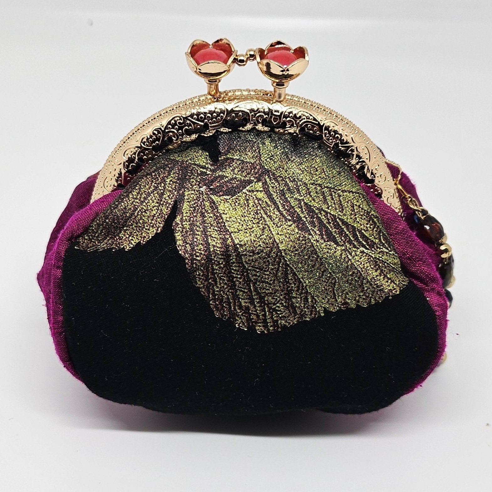 back view of Metallic rose print kiss clasp coin purse with beaded tassel.
