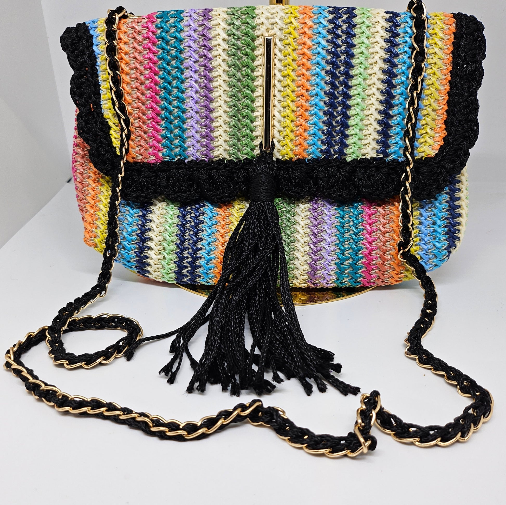 Front view of Rainbow striped crossbody with decorative tassel with strap