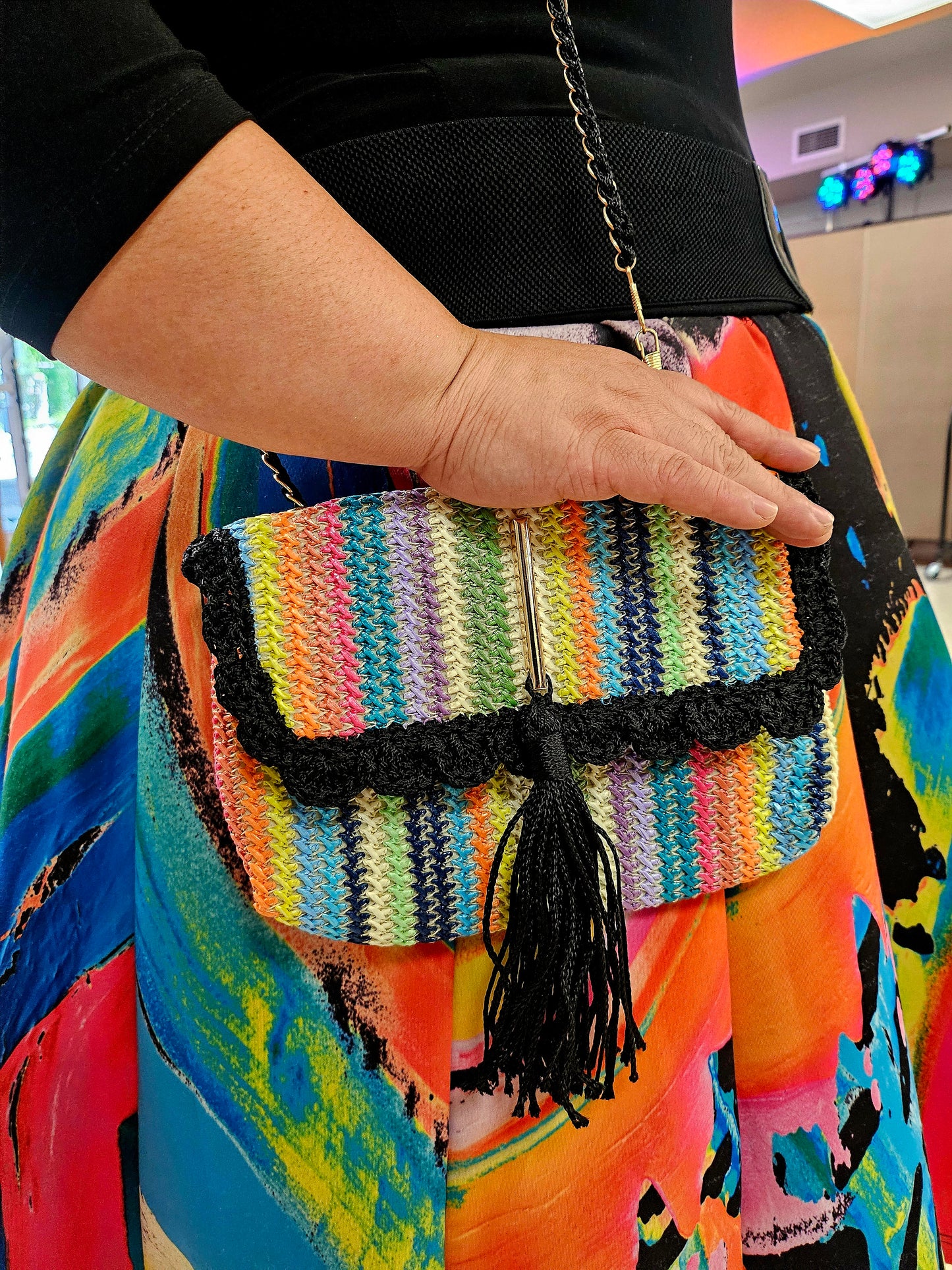 Rainbow striped crossbody with decorative tassel on model