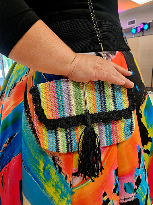 Rainbow striped crossbody with decorative tassel on model