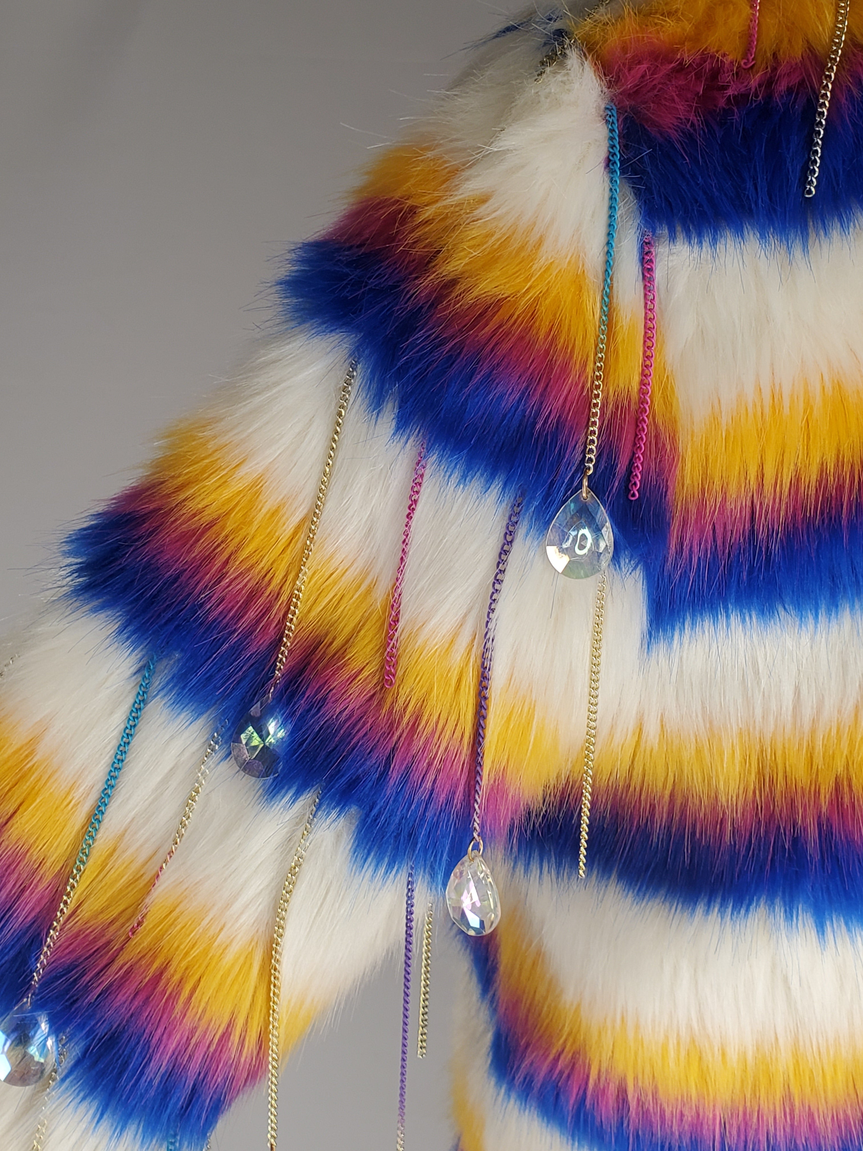close up view of statement sleeves on rainbow faux fur coat