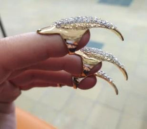Gold and diamond rhinestone fingertip rings on fingers side view