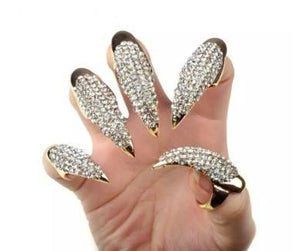 Gold and diamond rhinestone fingertip rings on fingers