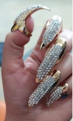Gold and diamond rhinestone fingertip rings on fingers front view