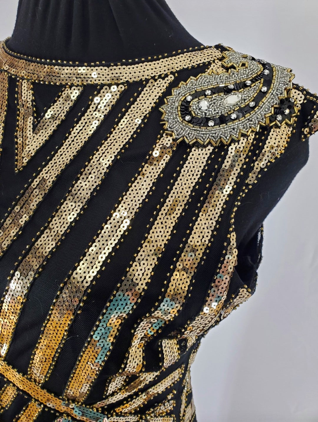 Shoulder applique detail on Art Deco-inspired beaded gown with detachable faux fur stole and appliques