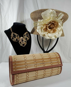 Beige wood slat clutch with golden abstract cloche accented with large cream flower and black rhinestone and gold chunky necklace.
