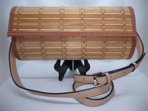 Nude colored wood crossbody handbag with beige pleather strap.