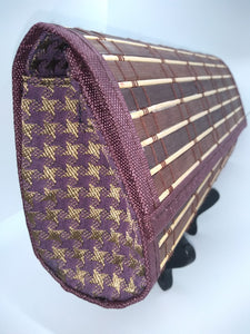 Side view of brown wood clutch with purple and gold hounds tooth side panels 