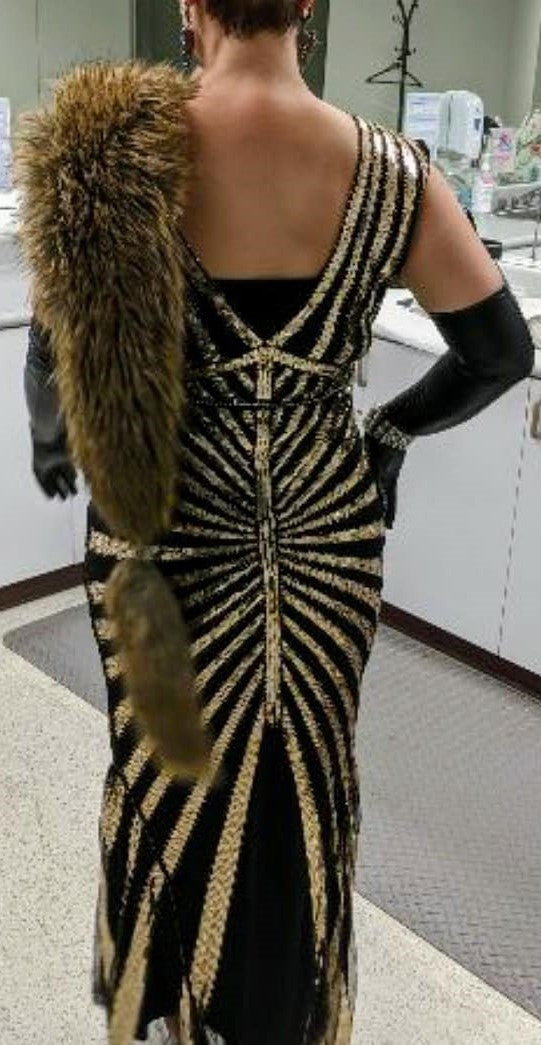 back view of Art Deco-inspired beaded gown with detachable faux fur stole and appliques on model